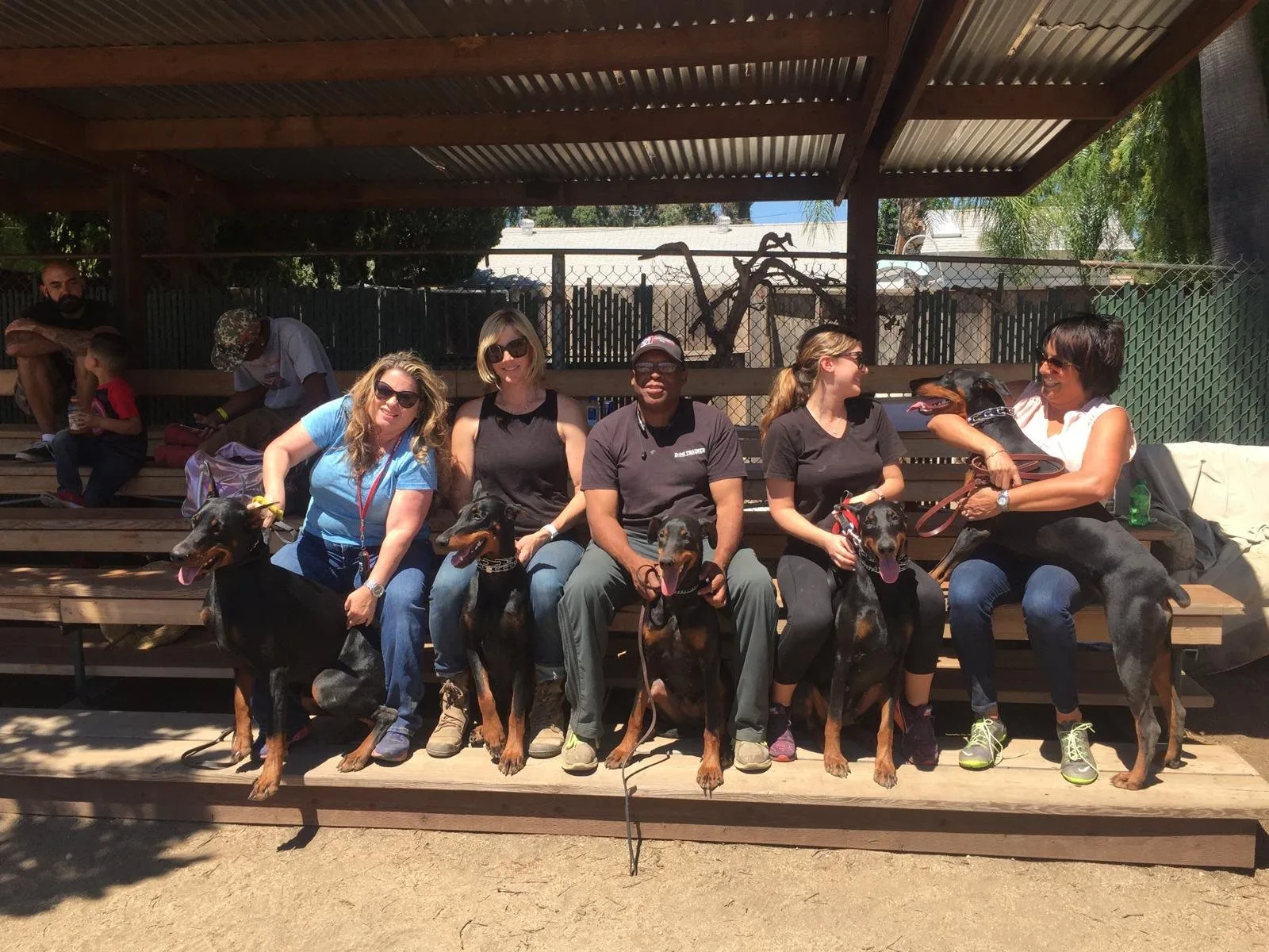 Daryl Young with clients and their Dobermans at America's Best Dog Trainers