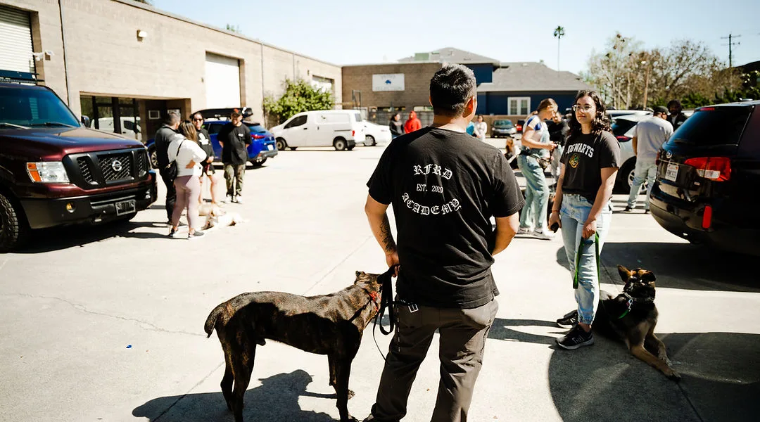 Candid shot of group brush up session in parking lot of facility.