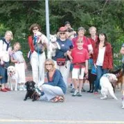 A group of people in the San Francisco Bay Area, posing for a photo with their dogs.