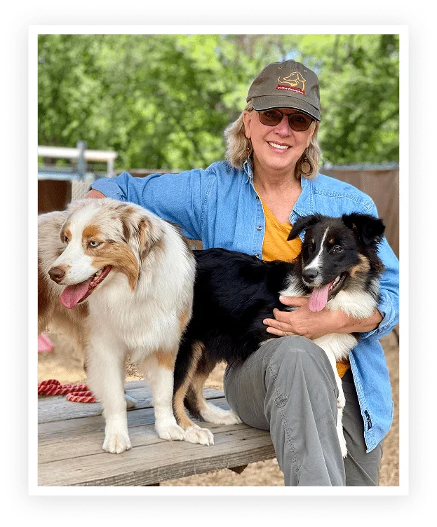 dr. sarah richardson sitting on a bench with two dogs