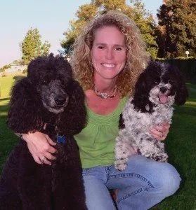 AboutJulie Schmitt2026-05-20T16:29:47-07:00Julie Schmitt trains dogs the same way she raises her kids.  As a mom of two girls, she knows that raising kids is not a “fix it and forget it” prospect, and the same is true when working with dogs.  She believes that when dogs act out, it’s too easy to lose sight of their moments of greatness, so she helps empower frustrated dog owners to create lasting change in their dogs, leading to improved behavior and more shared joy. The methods she employs represent a lifestyle choice.  They are the same practices that can be used to improve relationships with family members, friends, or co-workers.Vision: Keep it simple, appreciate the small things, find the joy.Julie has been a professional dog trainer for over 30 years.  She is the only dog trainer in San Diego who is a licensed Guide Dog Mobility Instructor (GDMI), Certified Professional Dog Trainer – Knowledge Assessed (CPDT-KA), Certified Victoria Stilwell Positively Dog Trainer (VSPDT), and a Certified Fear Free Professional.Who recommends her and where she can be foundShe is recommended by the El Cajon Animal Shelter, Coastview Veterinary Hospital, Cuyamaca Animal Hospital, El Cerrito Veterinarian Hospital, Judy Veterinary Clinic, Lake Murray Village Veterinary Clinic, Mast Blvd. Pet Hospital, Mission Valley Pet Clinic, Rancho San Carlos Vet Clinic, Santee Pet Hospital, Spring Valley Animal Medical Hospital, VCA Grossmont, numerous professional animal trainers and other pet professionals.  She can often be found working with clients at Fiesta Island, hiking trails at Cowles Mountain, or walking at Lake Murray.  Julie conducts many training sessions at parks throughout the East County, with specific emphasis on such neighborhoods as Del Cerro, Rolando, San Carlos, Santee, El Cajon, Lemon Grove, La Mesa, and Lakeside.CredentialsLicensed Guide Dog Mobility InstructorCertified Professional Dog Trainer- Knowledge AssessedCertified Victoria Stilwell Positive Dog TrainerCertified Fear Free ProfessionalLicensed Be a Tree Presenter (dog bite prevention for children)Member, The International Association of Animal Behavior ConsultantsProfessional Member, Association of Professional Dog TrainersHer storyIn 1996, Julie began working at the prestigious and world renowned  In 2002, Julie and her family moved to San Diego where she established Out N’ About Dog Training.  She was privileged to be approved as a Victoria Stilwell Positively Dog Trainer by Victoria Stilwell herself, star of Animal Planet’s hit TV series  and a passionate advocate for positive reinforcement training methods.Julie lives in La Mesa with her husband, who is a veterinarian. They have three terrific dogs and a cool salt water fish tank. Their two daughters also pop in and out of the house, as they practice “adulting.” Julie has a passion for her work and a love for animals that is evident in her training style. “I have a  2 year old Shiba Inu named Corner who has the name for a reason… Julie was an amazing dog trainer and a very professional person! I have never gone to a trainer or had one come to the house before because I was afraid of how they would treat Corner since he is like a kid to me. I found Julie online and chose her specifically because of her training philosophy. I didn’t want Corner to be punished during training and Julie’s training program is based upon rewards.  I am very impressed with this experience. Corner has had three sessions so far and has had remarkable improvements! He is a very smart/stubborn little guy and Julie knew just how to handle his antics. I highly recommend her to anyone! Its well worth it!” – Rachel